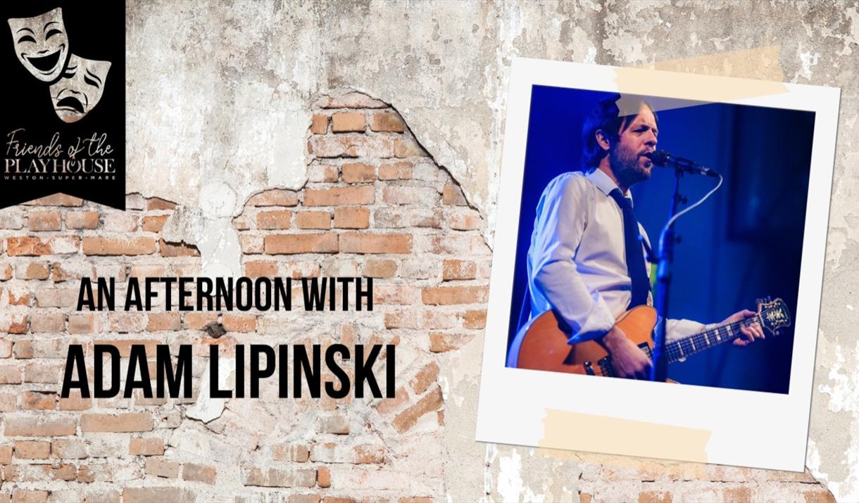 Photo of guitarist Adam Lipinski on a wall where the plaster is peeling to reveal the brickwork