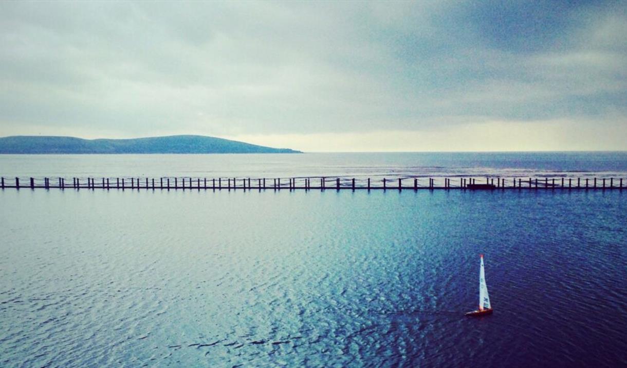 A picture of a sea scape with a single boat