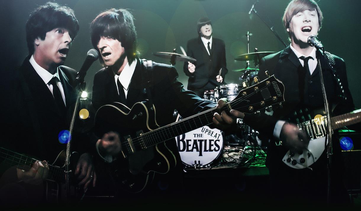 The Upbeat Beatles - photograph of tribute band as the Beatles playing instruments