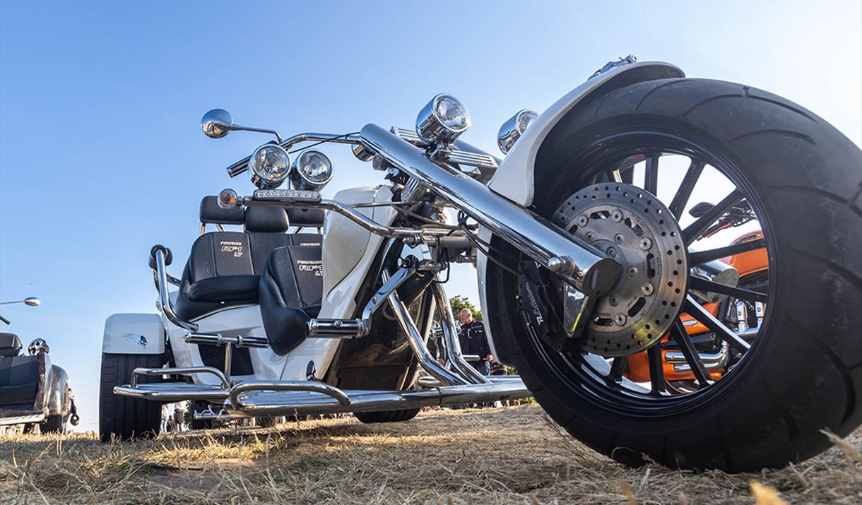 Very low viewpoint of a large silver motor trike