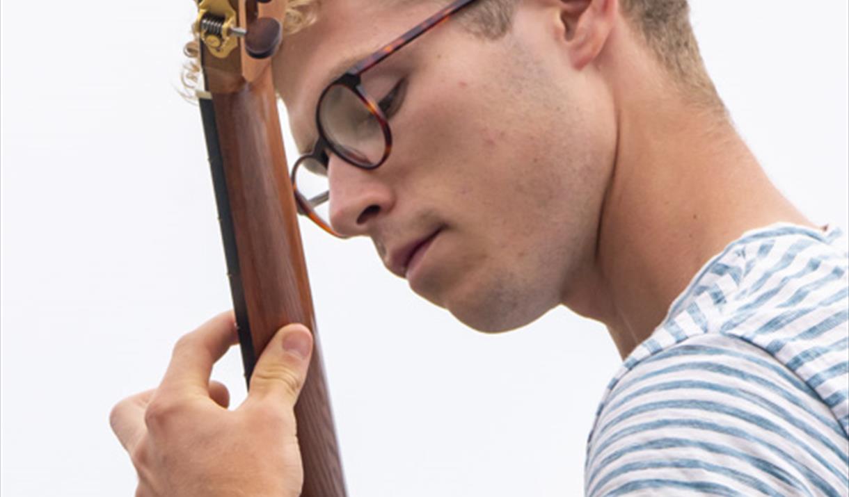 Ross Morris playing his guitar