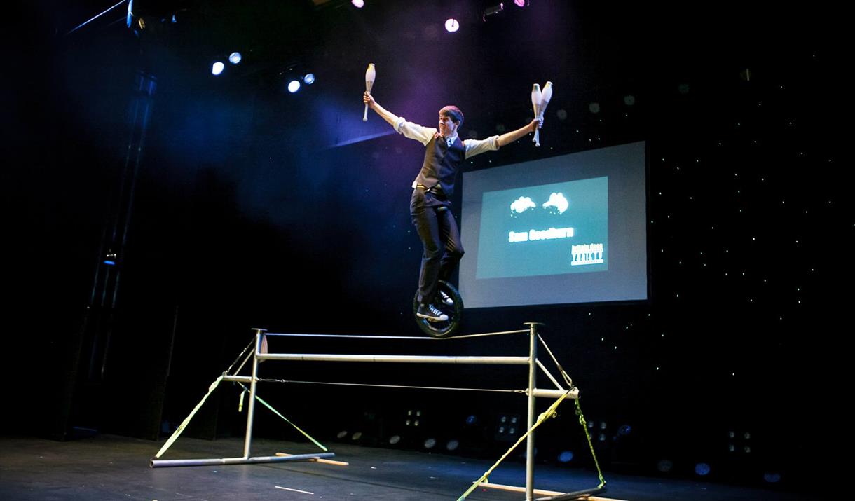 A juggler standing on top of a high wire