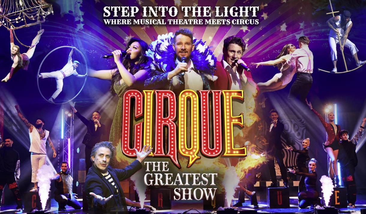 On the bottom left and right there are dancers/performers, in the top left is one women swinging from a chandler and one man doing tricks with a large