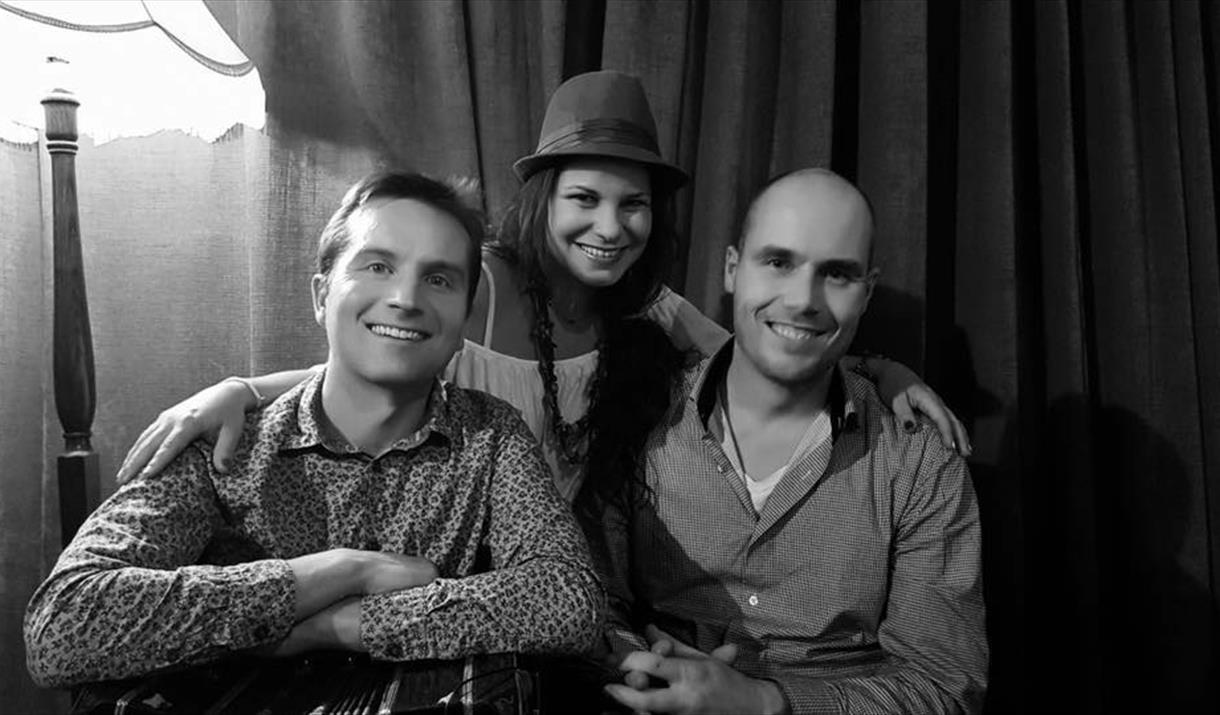 Black and White image of 3 band members looking to camera