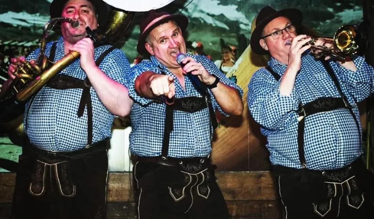 Three men dressed in Lederhosen