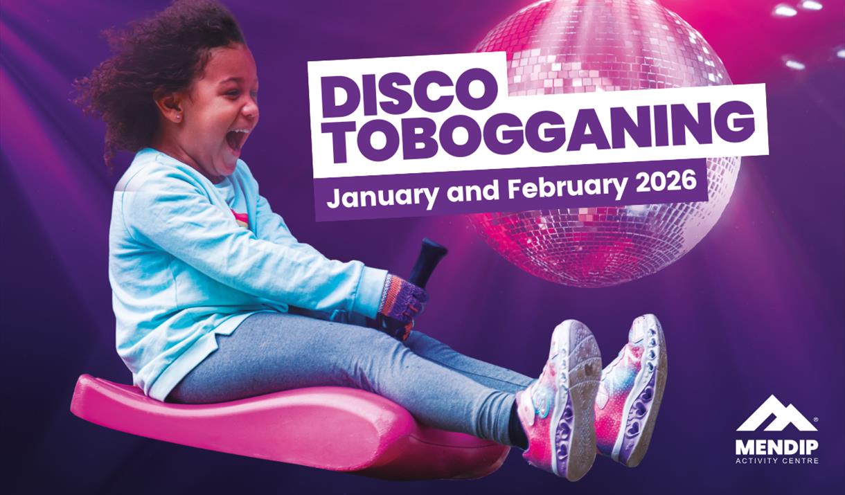 Child at Mendip Activity Centre laughing on a pink toboggan with a disco ball background and text reading 'Disco Tobogganing - January and February 20