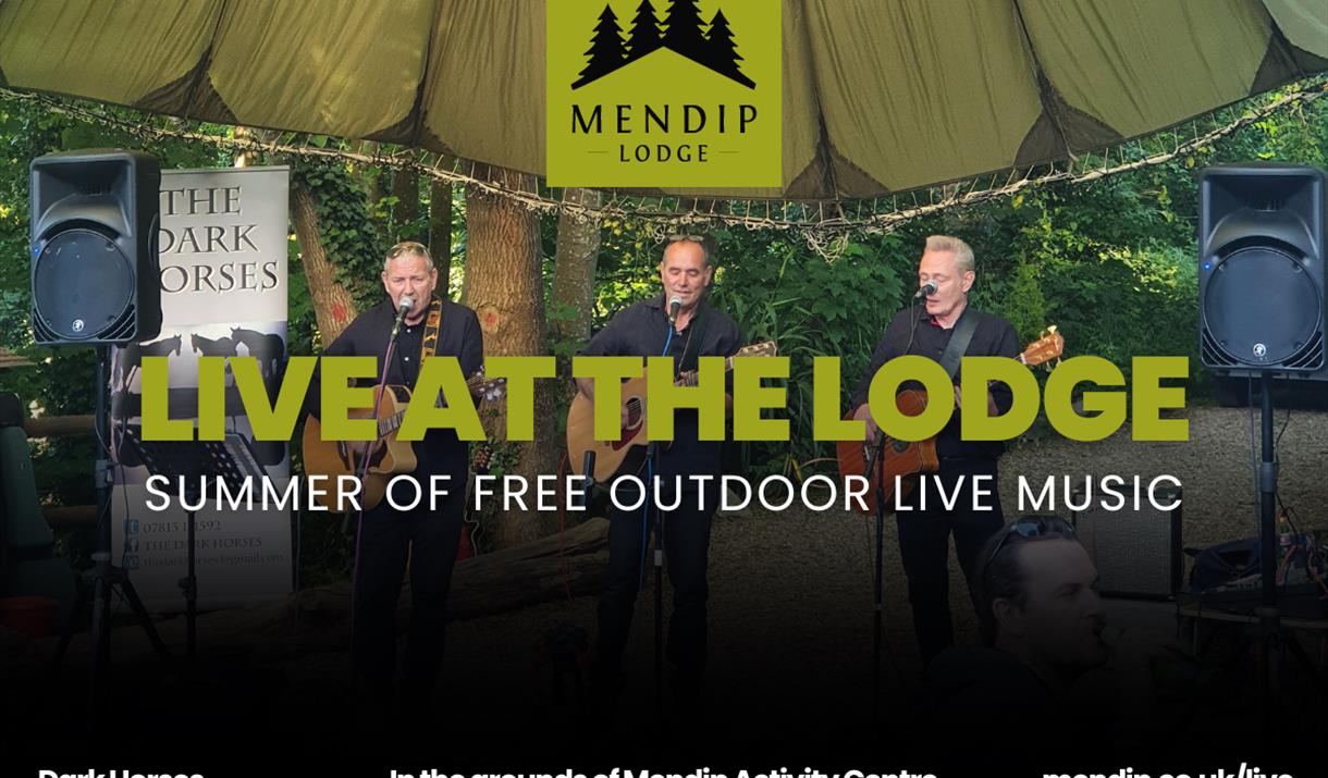 Three men playing guitar and singing into microphones under tented woodland canopy. Mendip Lodge logo. Text promotes Live at the Lodge: Summer of free