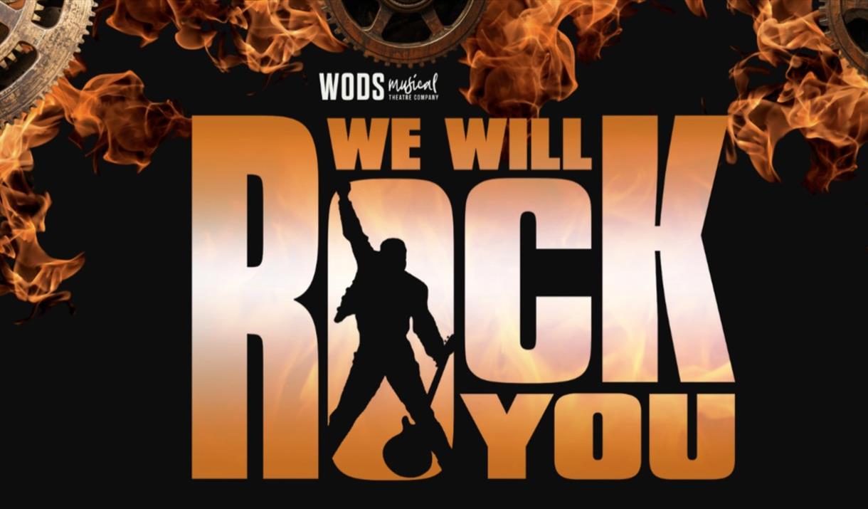 Silhouette of a guitarist in the O of the words We Will Rock You