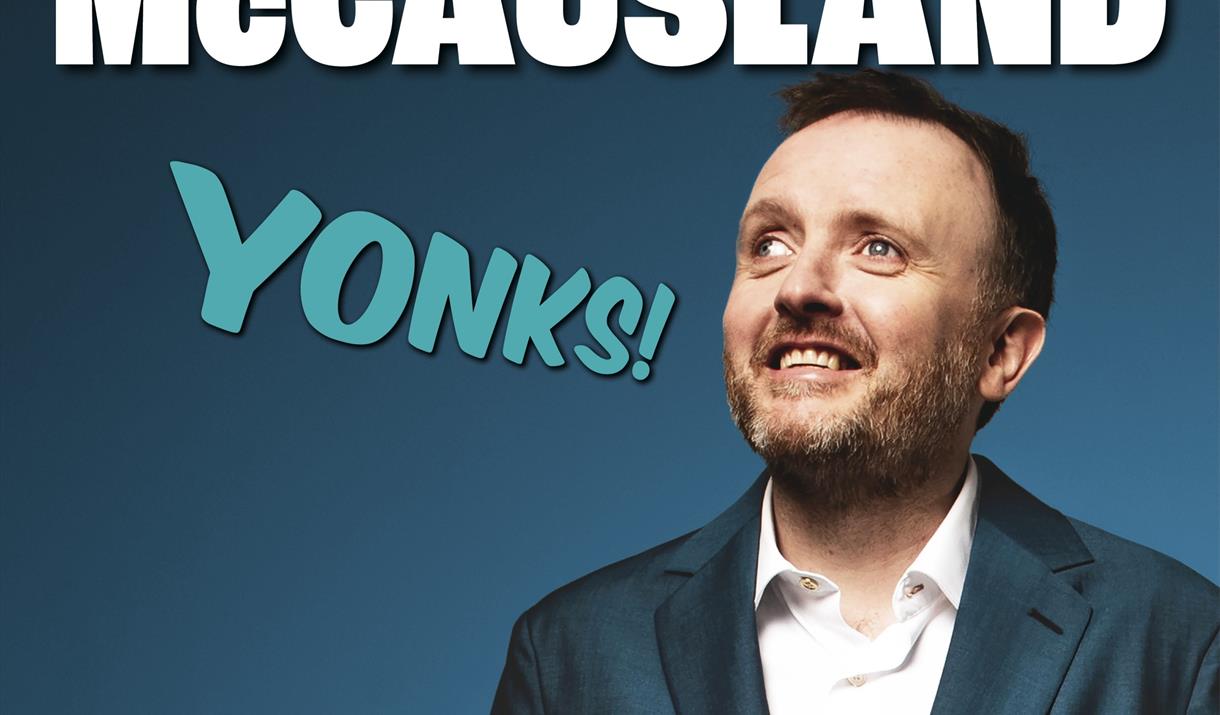 Photo of comedian Chris McCausland wearing a suit jacket and open necked white shirt on a poster advertising his stand-up show Yonks