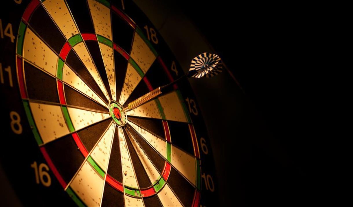 Dartboard with a dart in the bullseye