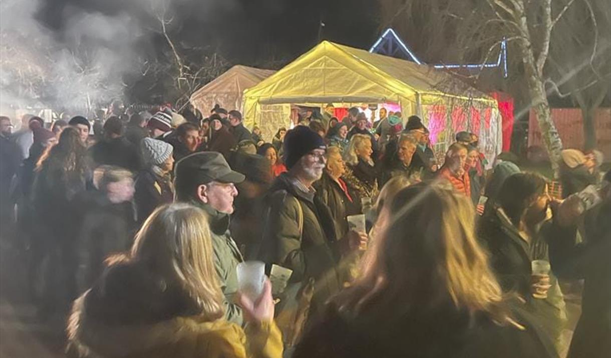 Crowds of people around an apple tree