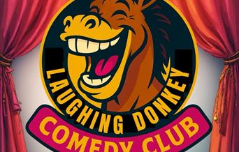 The cartoon head of a laughing donkey