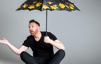 Jason Byrne with opened umbrella