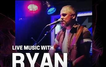 Musician Ryan Haynes singing into a microphone