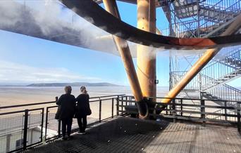 Showing how clouds are formed with 2 ladies standing on the platform taking in the view over the sea to Brean Down