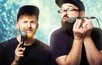 Two comedians with microphones