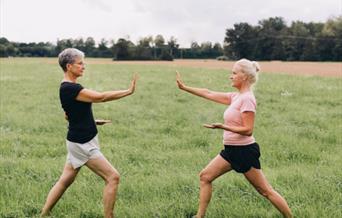 Women doing Tai chi outdoors