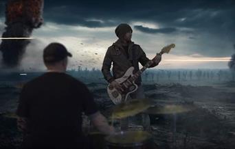guitarist in dark open landscape, crows and ominous people surrounding.
