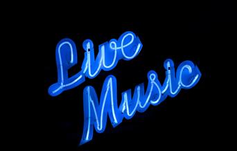 A neon blue sign on a black background saying Live Music