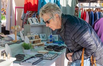 A lady browsing the jewellery store at the Weston-super-Mare weekly market