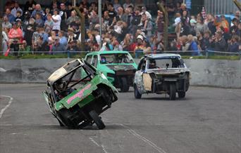 Three Robin Reliant cars in a banger racing race