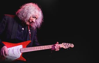 Albert Lee playing a red guitar