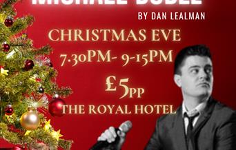 An evening of Michael Buble by Dan Lealman.  Photograph of Dan with a green Christmas tree and presents underneath the tree.