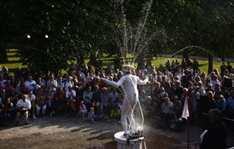 Photograph of Spurting Man on plinth, squirting water from his costume