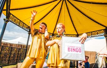 Singers wearing yellow on the bandstand