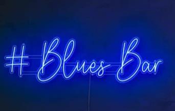 Blues bar lit up in neon lights