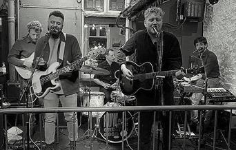 Black and white picture of the Greater Good band