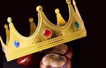 A golden crown on top of three conkers to advertise a conkers competition in Weston-super-Mare