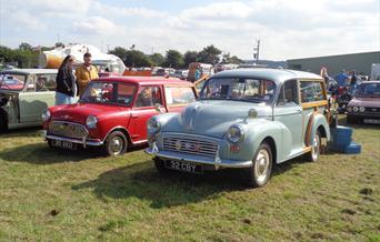 A Morris Minor and a red Mini from previous displays