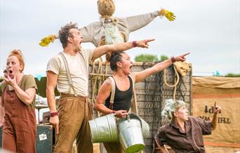 Four actors from the Farmyard Circus Group looking shocked as they point to something in the distance