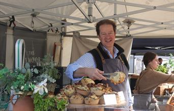 A stall holder serving a customer at the Eat;Weston Food Festival