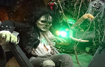 A white faced Halloween character in a grisly environment