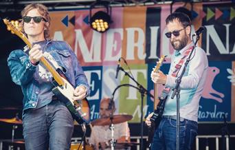 Lipinski Bros playing guitars on stage.