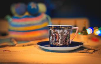 Photograph of a china cup and saucer in dark blue.