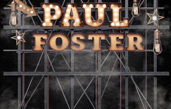 Photograph of Paul Foster's name in lights on a stage.