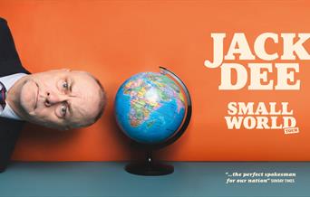 Picture of comedian Jack Dee lying on his side with his head close to a globe to advertise his Small World tour