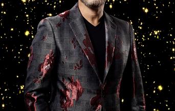 Jon Fisher as Gary Barlow - image of Gary Barlow against a black and gold.