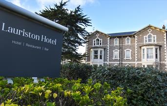 Exterior of the hotel with large grey sign saying Lauriston Hotel on a grey background