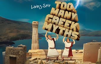 Cartoon style image featuring two men in white togas lifting up stone blocks spelling out the words Too Many Greek Myths while standing on top of an a