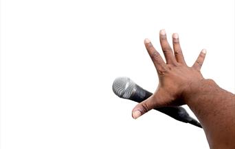 Open Mic Night - a hand dropping a microphone.