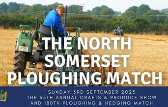 Farmer sitting on tractor looking over his shoulder at his ploughing machine