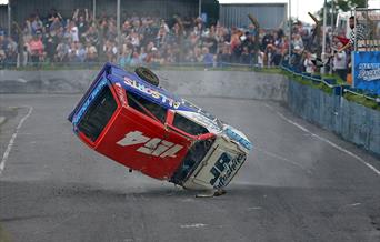 An upside-down banger racing car lands on its front headlight