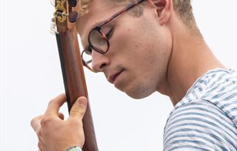 Ross Morris playing his guitar