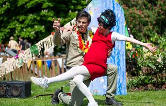 A photograph of an Elvis impersonator with his assistant.