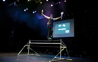 A juggler standing on top of a high wire