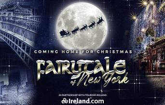 On the left is a snow covered bridge and buildings. On the right is a building covered in lights and the title is in the centre under a moon.